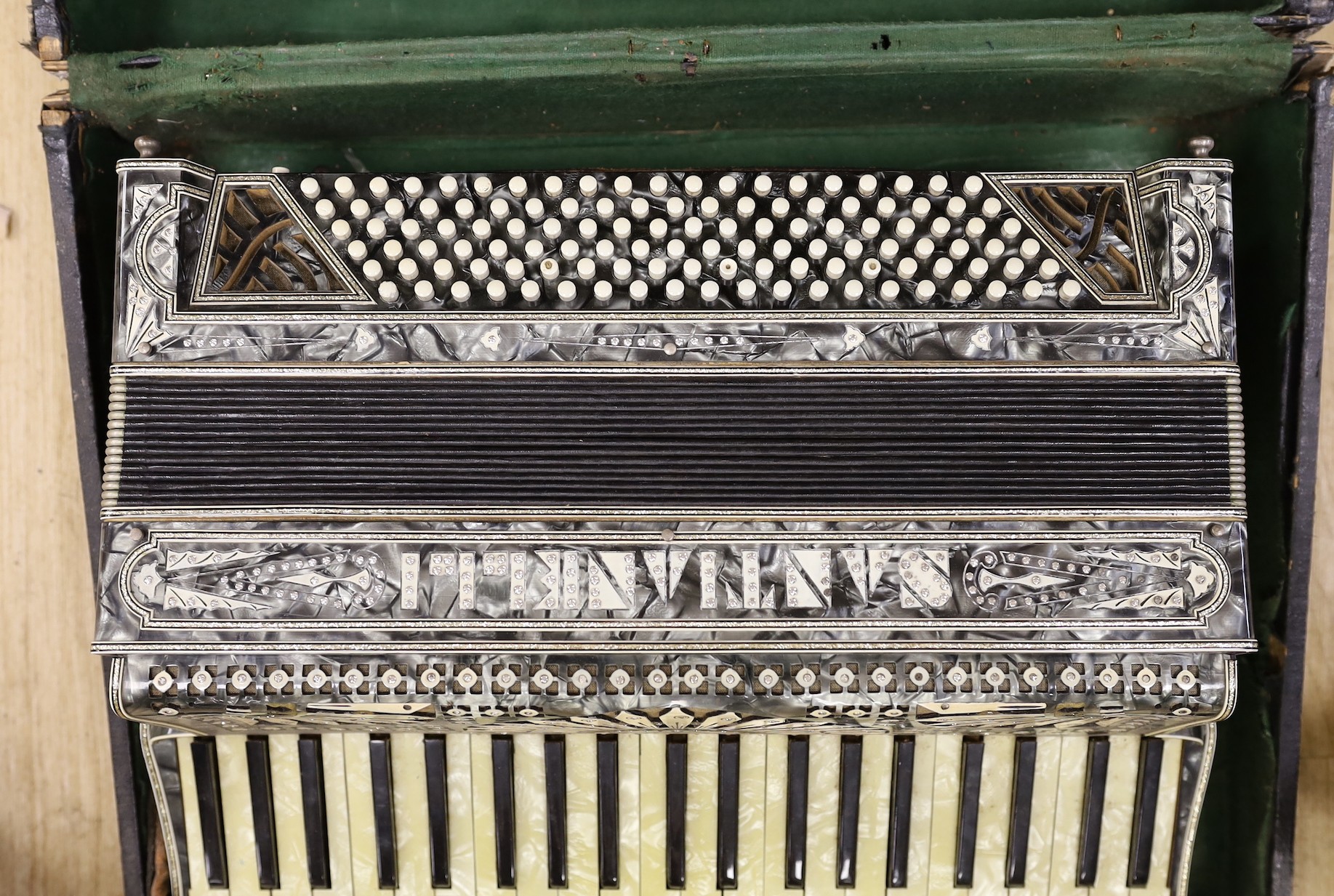 A cased Santiarelli cased accordion, 51 cms wide